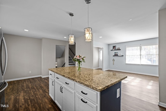 1195 Champion Dr, Cary, NC 27511 - kitchen featuring dark wood finished floors, a center island, light stone countertops, baseboards, and recessed lighting