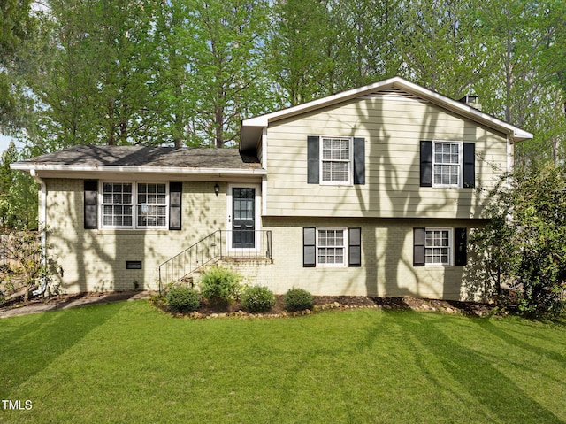 1195 Champion Dr, Cary, NC 27511 - tri-level home featuring brick siding and a front lawn