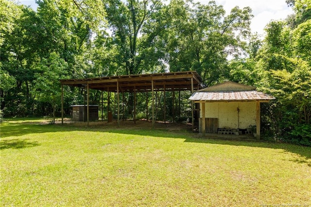 5648 Tolarsville Rd, Saint Pauls, NC 28384 - view of green lawn with a detached carport and an outdoor structure