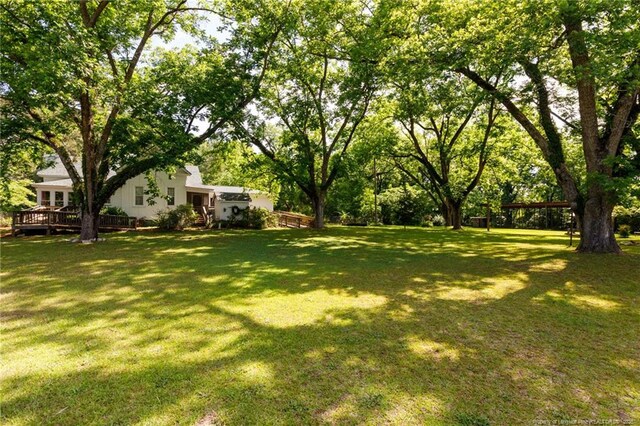 5648 Tolarsville Rd, Saint Pauls, NC 28384 - view of green lawn featuring a deck