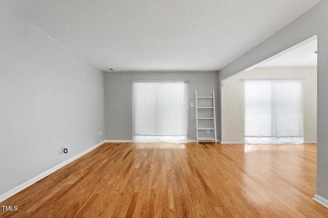 4705 Walden Pond Dr Unit 110-C, Raleigh, NC 27604 - unfurnished room with a textured ceiling, light wood finished floors, and baseboards