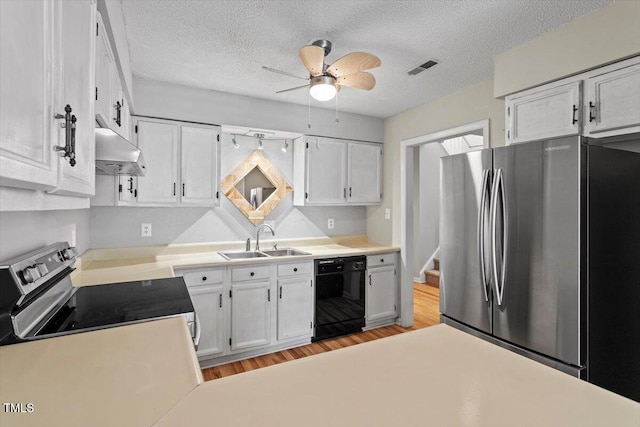 4705 Walden Pond Dr Unit 110-C, Raleigh, NC 27604 - kitchen featuring stainless steel appliances, a sink, under cabinet range hood, ceiling fan, and white cabinetry