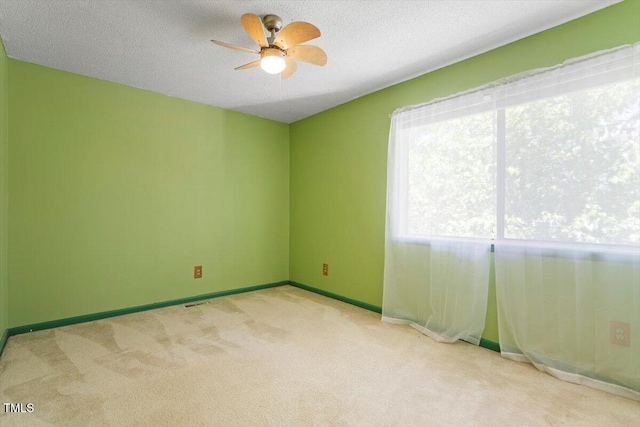 4705 Walden Pond Dr Unit 110-C, Raleigh, NC 27604 - carpeted empty room with a ceiling fan, baseboards, and a textured ceiling