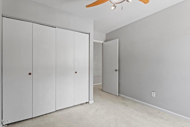 4705 Walden Pond Dr Unit 110-C, Raleigh, NC 27604 - unfurnished bedroom featuring a closet, carpet flooring, a textured ceiling, ceiling fan, and baseboards