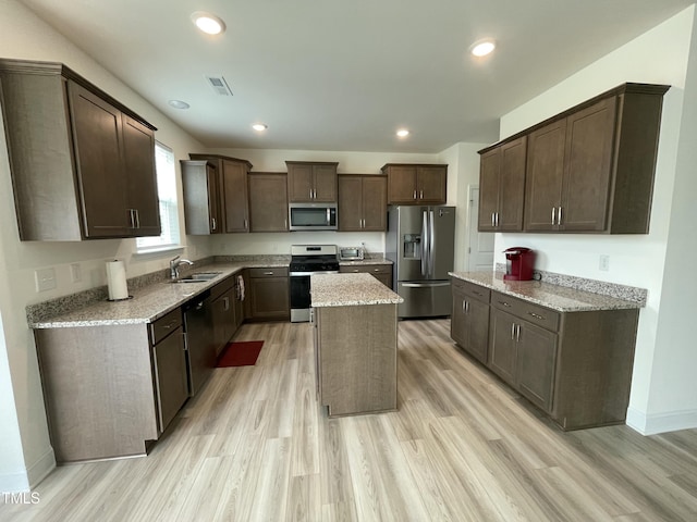 30 Junius Birch Trl, Franklinton, NC 27525 - kitchen with appliances with stainless steel finishes, a sink, dark brown cabinetry, light wood-style flooring, and recessed lighting