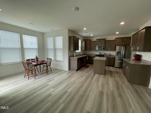 30 Junius Birch Trl, Franklinton, NC 27525 - kitchen with appliances with stainless steel finishes, a sink, dark brown cabinetry, baseboards, and light wood-style flooring