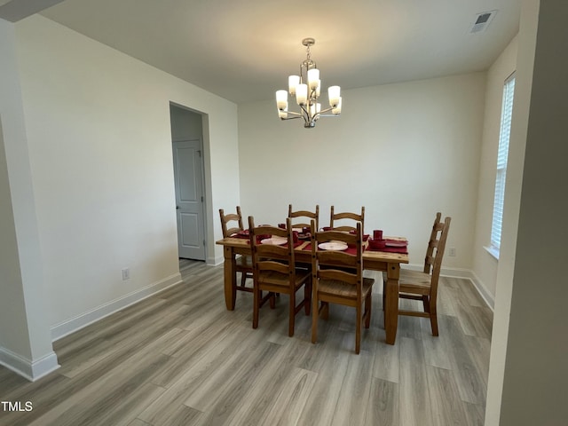 30 Junius Birch Trl, Franklinton, NC 27525 - dining room featuring a chandelier, light wood-style flooring, and baseboards