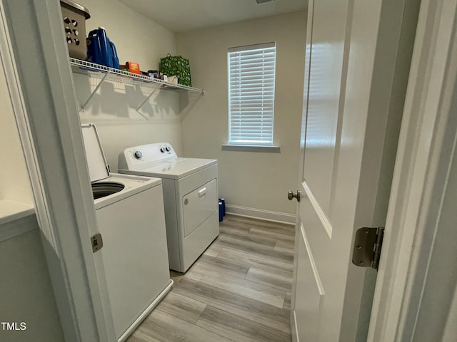 30 Junius Birch Trl, Franklinton, NC 27525 - laundry room featuring separate washer and dryer, light wood-style floors, and baseboards
