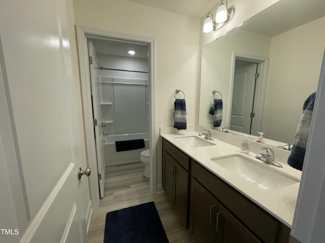 30 Junius Birch Trl, Franklinton, NC 27525 - full bath featuring double vanity, toilet, shower / bathtub combination, and wood finished floors