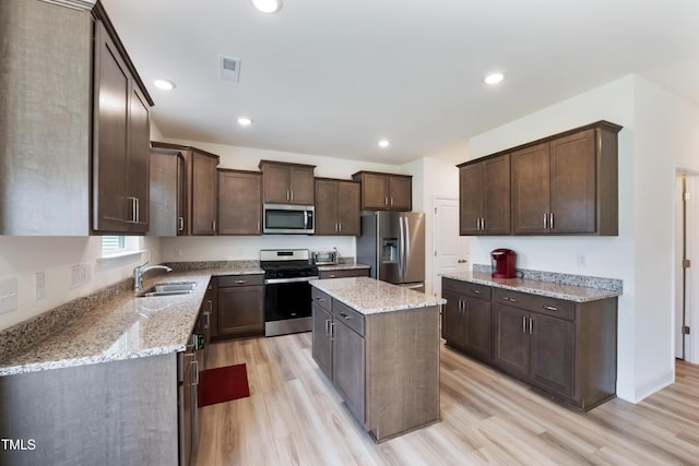 30 Junius Birch Trl, Franklinton, NC 27525 - kitchen featuring appliances with stainless steel finishes, dark brown cabinetry, light wood-style flooring, and recessed lighting
