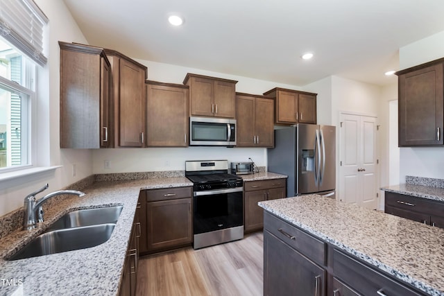 30 Junius Birch Trl, Franklinton, NC 27525 - kitchen with appliances with stainless steel finishes, light stone counters, recessed lighting, light wood-style floors, and dark brown cabinets