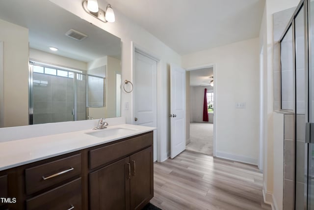 30 Junius Birch Trl, Franklinton, NC 27525 - bathroom featuring vanity, wood finished floors, a stall shower, and ceiling fan