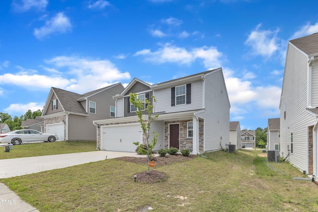 717 Little Patch St, Zebulon, NC 27597 - view of front of property with central AC unit, concrete driveway, a garage, and stone siding