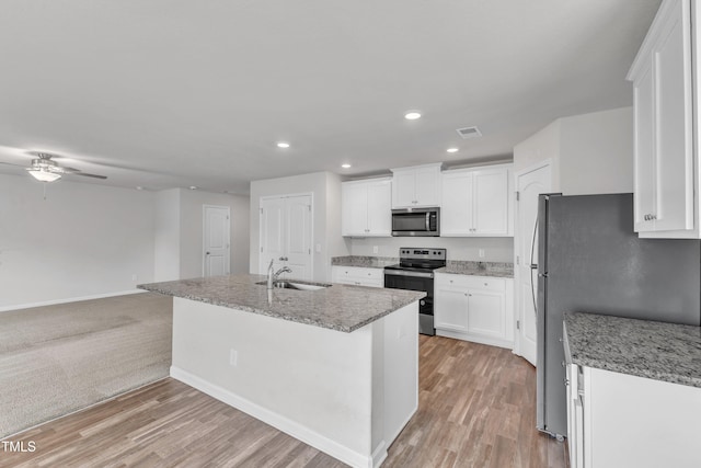 717 Little Patch St, Zebulon, NC 27597 - kitchen with appliances with stainless steel finishes, a sink, recessed lighting, white cabinets, and light wood-type flooring