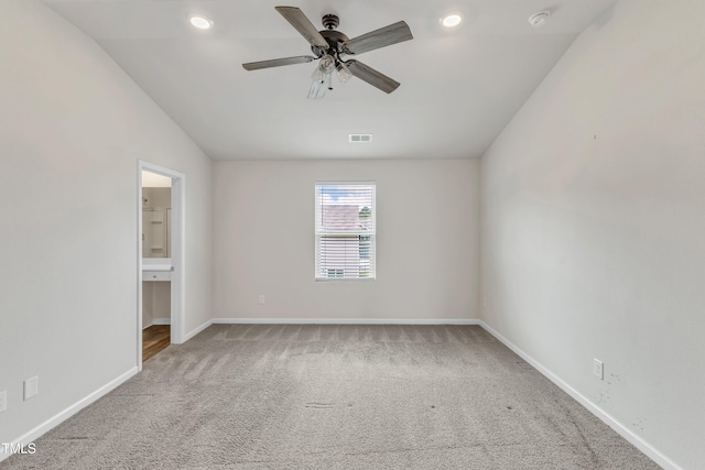 717 Little Patch St, Zebulon, NC 27597 - unfurnished bedroom featuring carpet, baseboards, vaulted ceiling, recessed lighting, and connected bathroom