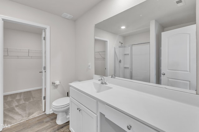 717 Little Patch St, Zebulon, NC 27597 - full bathroom featuring a stall shower, toilet, vanity, wood finished floors, and recessed lighting