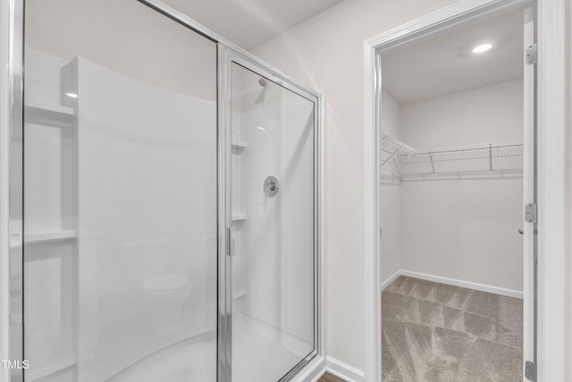 717 Little Patch St, Zebulon, NC 27597 - bathroom with a stall shower, a spacious closet, and baseboards