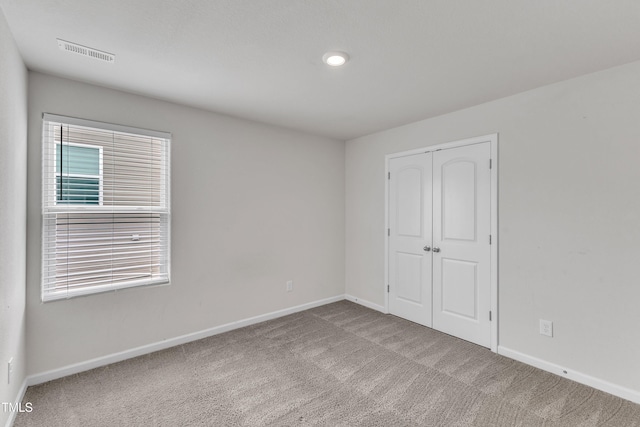 717 Little Patch St, Zebulon, NC 27597 - unfurnished bedroom featuring carpet flooring, baseboards, and a closet