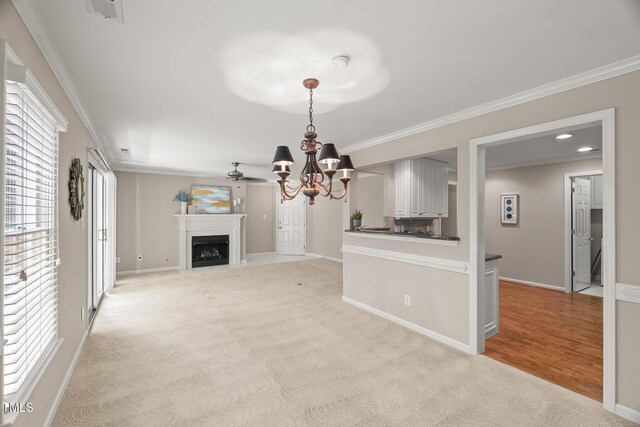 313 Glen Echo Ln Unit J, Cary, NC 27518 - unfurnished living room with a fireplace, light colored carpet, ornamental molding, a chandelier, and baseboards