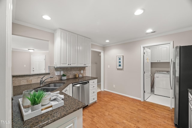 313 Glen Echo Ln Unit J, Cary, NC 27518 - kitchen featuring washer / dryer, appliances with stainless steel finishes, a sink, recessed lighting, and white cabinets