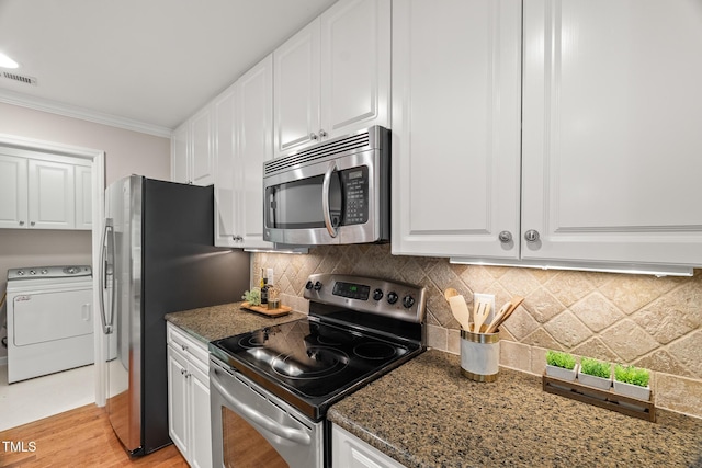 313 Glen Echo Ln Unit J, Cary, NC 27518 - kitchen with appliances with stainless steel finishes, washer / clothes dryer, white cabinets, ornamental molding, and tasteful backsplash