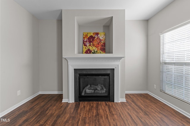 821 Stackhurst Way, Wake Forest, NC 27587 - detailed view of wood finished floors, baseboards, and a fireplace