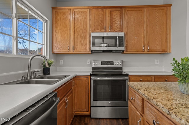 821 Stackhurst Way, Wake Forest, NC 27587 - kitchen with stainless steel appliances, a sink, light countertops, dark wood finished floors, and brown cabinetry