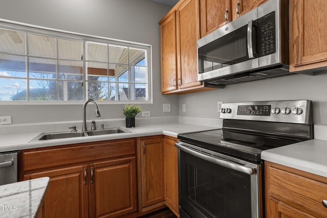 821 Stackhurst Way, Wake Forest, NC 27587 - kitchen featuring appliances with stainless steel finishes, a sink, healthy amount of natural light, and light countertops