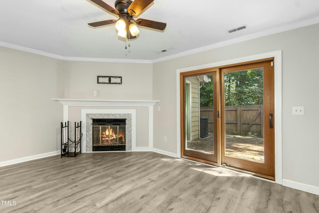2233 Alpine Rd, Durham, NC 27707 - unfurnished living room with crown molding, wood finished floors, baseboards, ceiling fan, and a fireplace