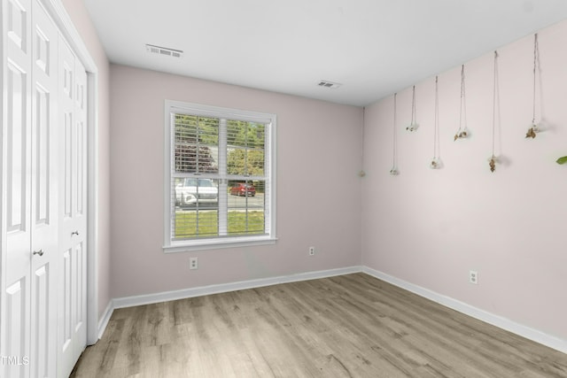 2233 Alpine Rd, Durham, NC 27707 - unfurnished bedroom with light wood-style flooring, baseboards, and a closet