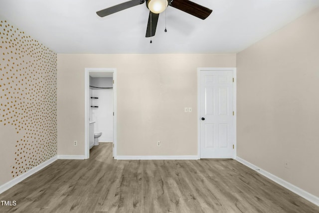 2233 Alpine Rd, Durham, NC 27707 - unfurnished bedroom with wood finished floors, baseboards, connected bathroom, and ceiling fan