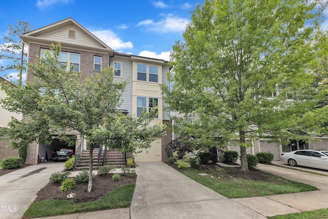 218 Irving Way, Durham, NC 27703 - townhome / multi-family property with brick siding, concrete driveway, and an attached garage