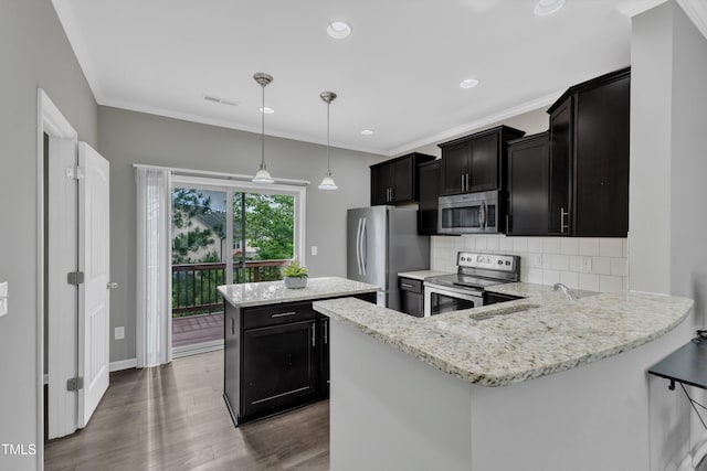 218 Irving Way, Durham, NC 27703 - kitchen featuring stainless steel appliances, dark cabinetry, a sink, a center island, and backsplash