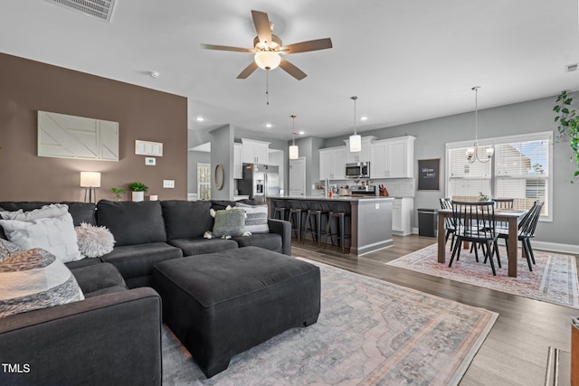 784 Cypress Rd, Cameron, NC 28326 - living area with a ceiling fan, wood finished floors, a chandelier, recessed lighting, and baseboards