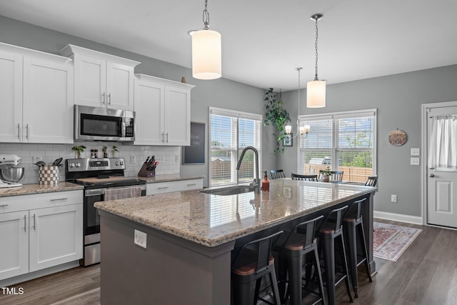 784 Cypress Rd, Cameron, NC 28326 - kitchen with appliances with stainless steel finishes, a sink, dark wood-style flooring, and a kitchen island with sink