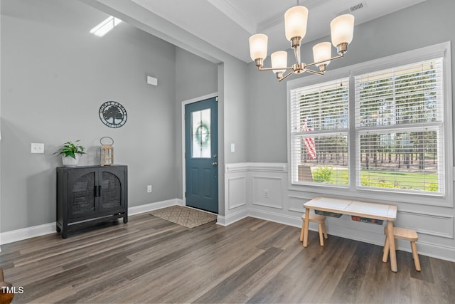 784 Cypress Rd, Cameron, NC 28326 - entryway with a chandelier, dark wood-style floors, wainscoting, crown molding, and a decorative wall