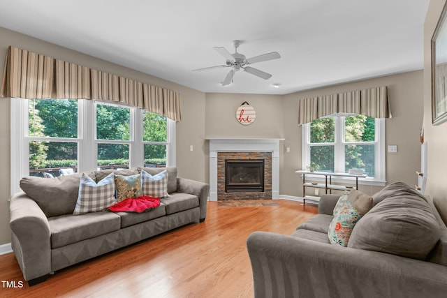 8536 Wolverton Fields Dr, Wake Forest, NC 27587 - living area featuring light wood-type flooring, ceiling fan, a fireplace, and baseboards