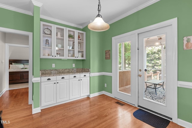 8536 Wolverton Fields Dr, Wake Forest, NC 27587 - entryway with light wood-style floors, crown molding, and baseboards