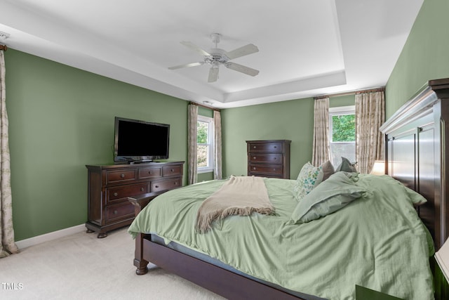 8536 Wolverton Fields Dr, Wake Forest, NC 27587 - bedroom featuring a tray ceiling, light colored carpet, baseboards, and ceiling fan