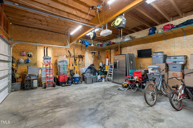 8536 Wolverton Fields Dr, Wake Forest, NC 27587 - garage with stainless steel refrigerator with ice dispenser and a garage door opener