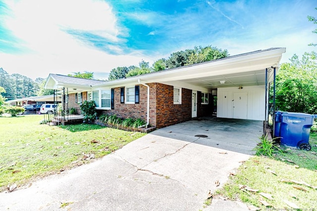 2911 Wicker St, Sanford, NC 27330 - ranch-style home with concrete driveway, a front yard, brick siding, and a carport