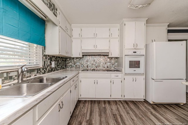 2911 Wicker St, Sanford, NC 27330 - kitchen featuring white appliances, a sink, white cabinets, dark wood-style floors, and light countertops