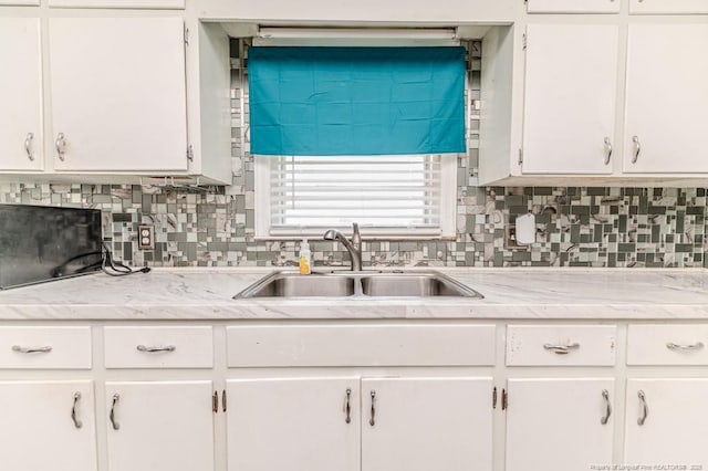 2911 Wicker St, Sanford, NC 27330 - kitchen with a sink, light countertops, and white cabinetry
