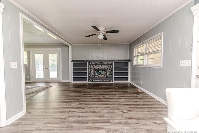 2911 Wicker St, Sanford, NC 27330 - unfurnished living room featuring a ceiling fan, crown molding, french doors, wood finished floors, and a fireplace