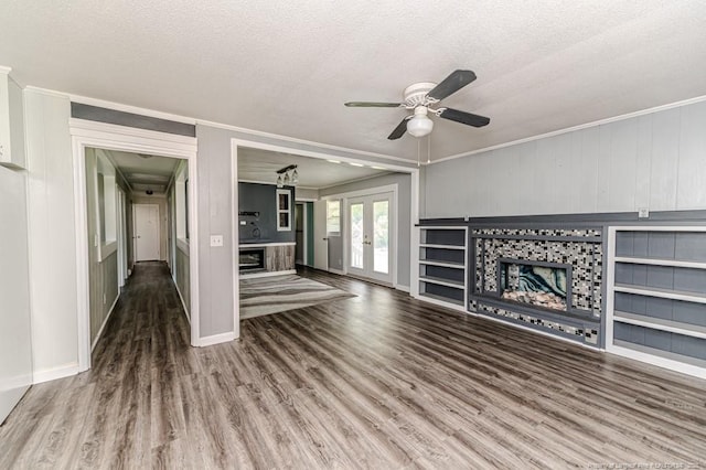 2911 Wicker St, Sanford, NC 27330 - unfurnished living room featuring a tile fireplace, wood finished floors, a ceiling fan, a textured ceiling, and ornamental molding