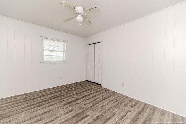 2911 Wicker St, Sanford, NC 27330 - unfurnished bedroom with wood finished floors, a closet, and ceiling fan