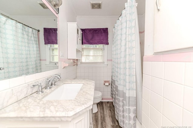 2911 Wicker St, Sanford, NC 27330 - full bath with tile walls, ornamental molding, wood finished floors, toilet, and vanity