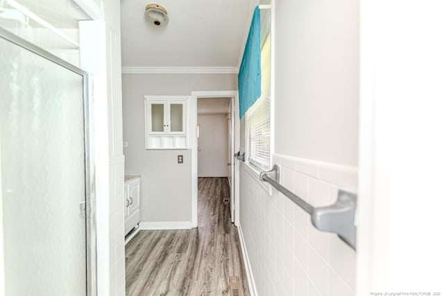 2911 Wicker St, Sanford, NC 27330 - corridor featuring ornamental molding, light wood-style flooring, and tile walls