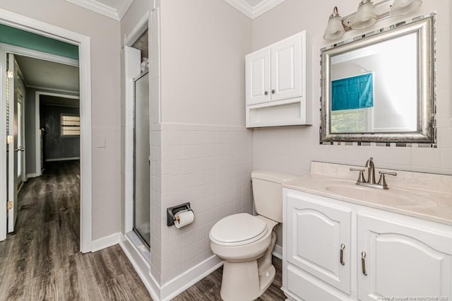 2911 Wicker St, Sanford, NC 27330 - full bathroom with ornamental molding, wood finished floors, tile walls, a shower stall, and vanity