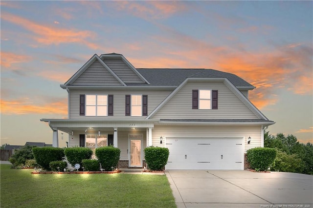 view of front of house featuring concrete driveway, a yard, a garage, a porch, and brick siding